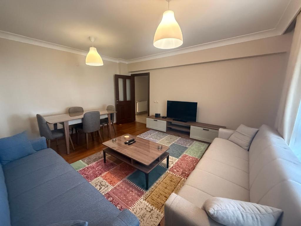 a living room with a couch and a table at Corner splash in Ankara