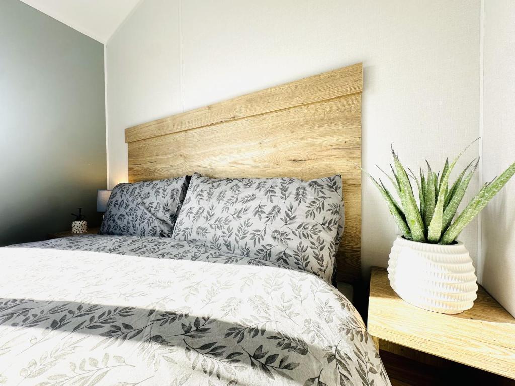 ein Schlafzimmer mit einem Bett und eine Vase mit einer Pflanze in der Unterkunft Moor Crest in Scarborough