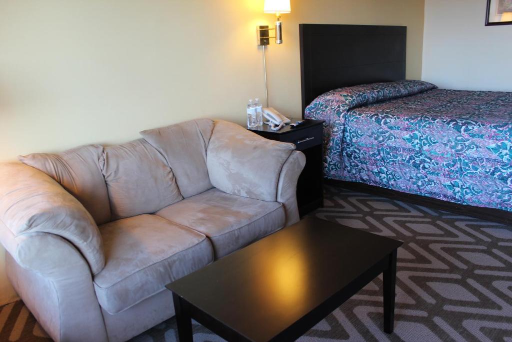 a living room with a couch and a bed at Tourway Inn in Birmingham