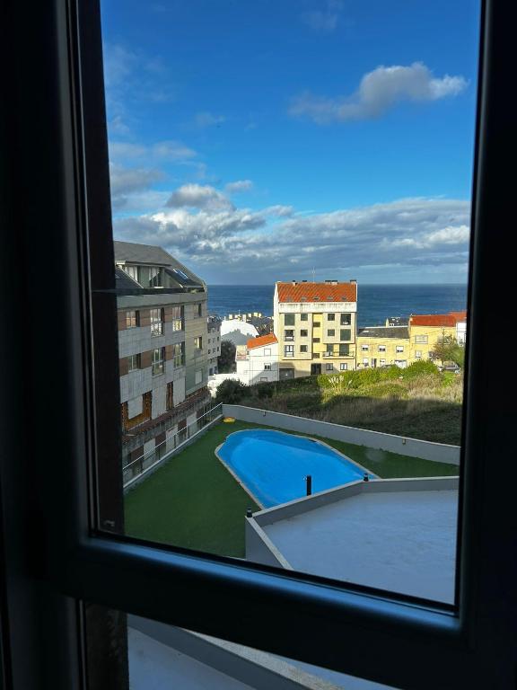 a view of a pool from a window at Malpica Beach in Malpica