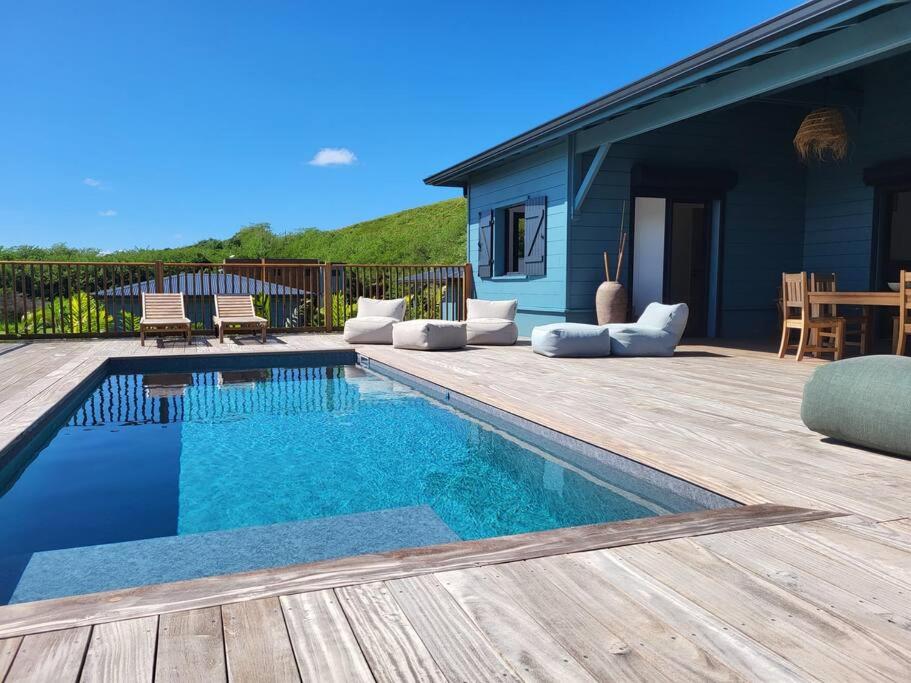 a backyard with a swimming pool and a wooden deck at SALTY LODGE Villa 3 chambres piscine "ALIZES" - Pointe Faula in Le Vauclin