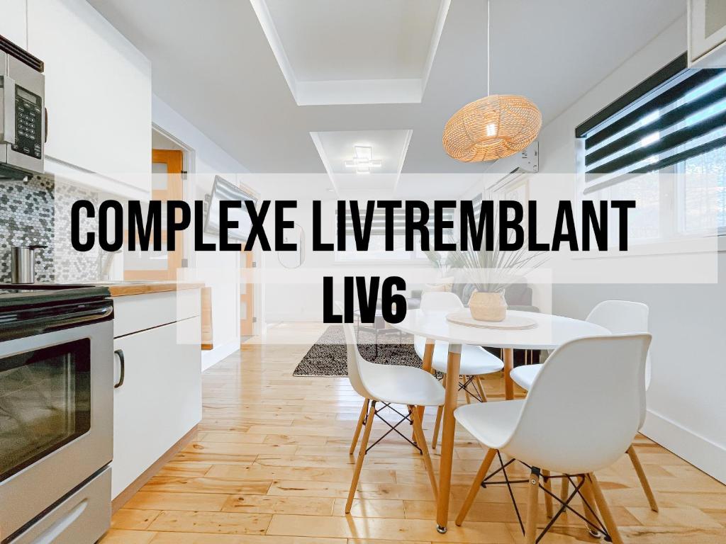 a kitchen with a table and chairs with the words compete immigrant live at Complexe LIVTremblant by Gestion ELITE - LIV6 in Mont-Tremblant