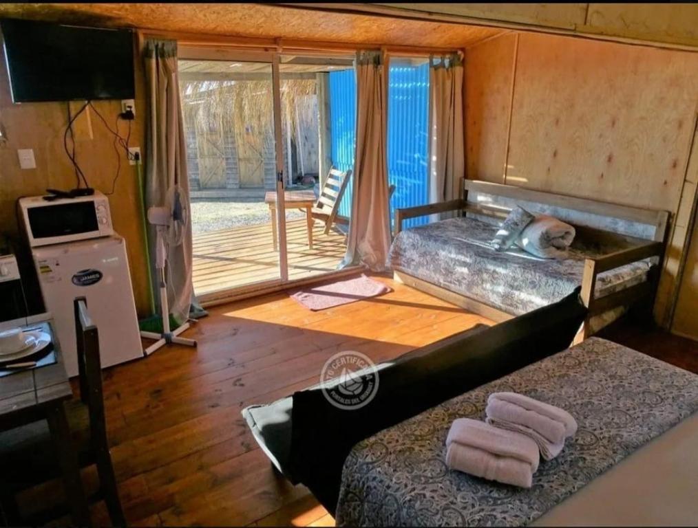 a room with a dog laying in a bed at Vida buena in Punta Del Diablo