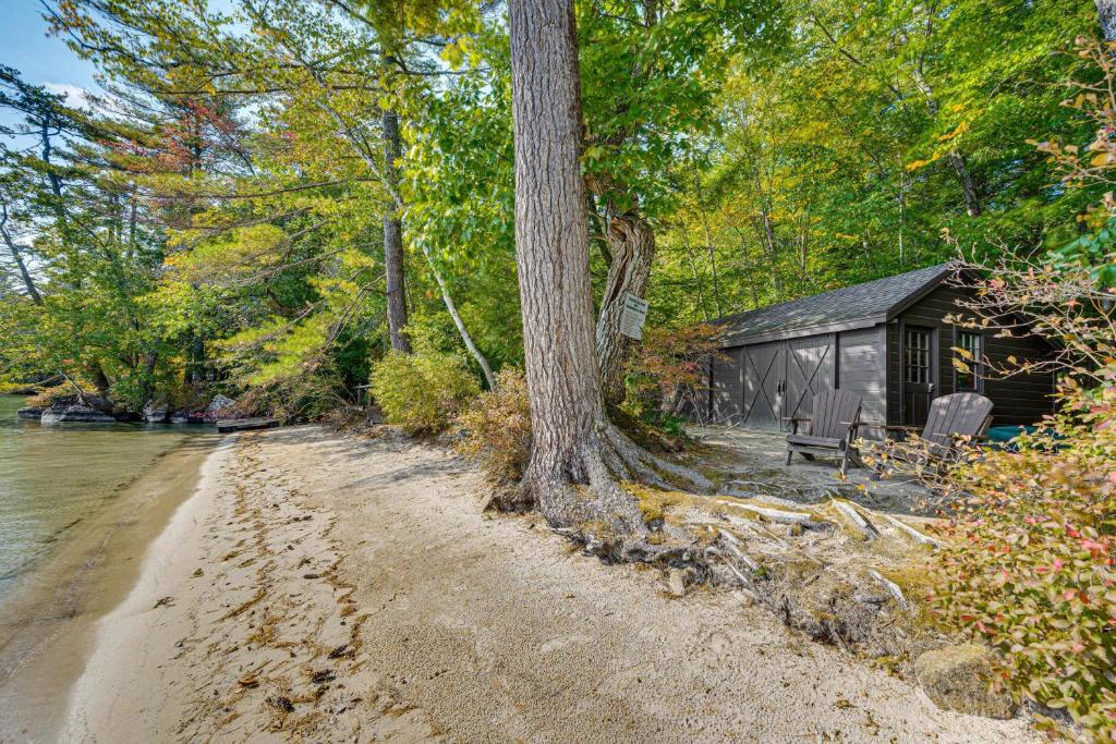 a cabin on the shore of a river next to a beach at Rustic Cabin w/ Squam Lake Access & Fireplace! in Holderness