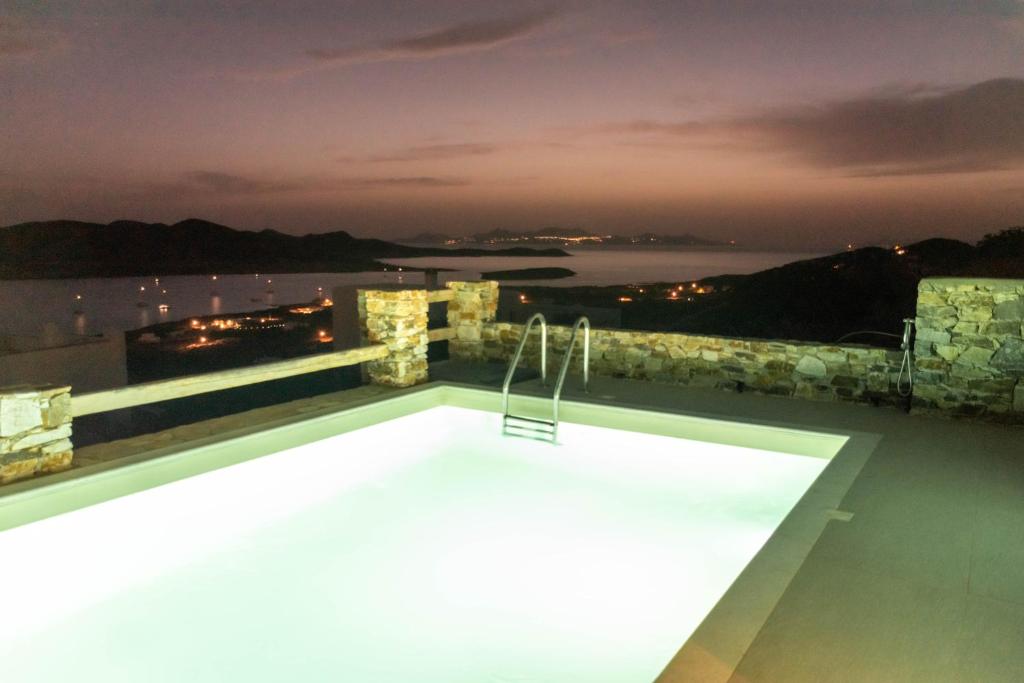 a pool on the roof of a building at night at Deja Blue Villa 1 in Agios Georgios