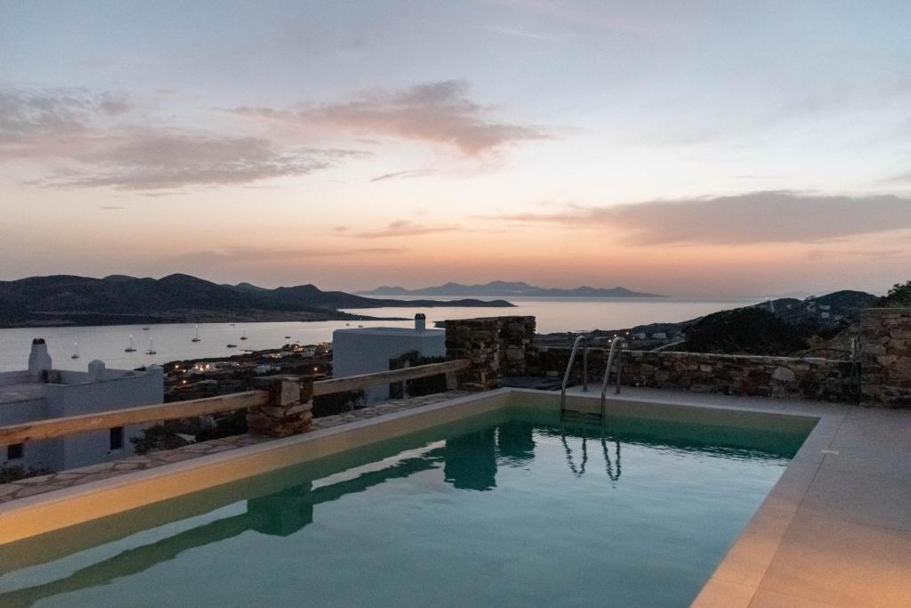 a swimming pool with a view of the water at Deja Blue Villa 1 in Agios Georgios