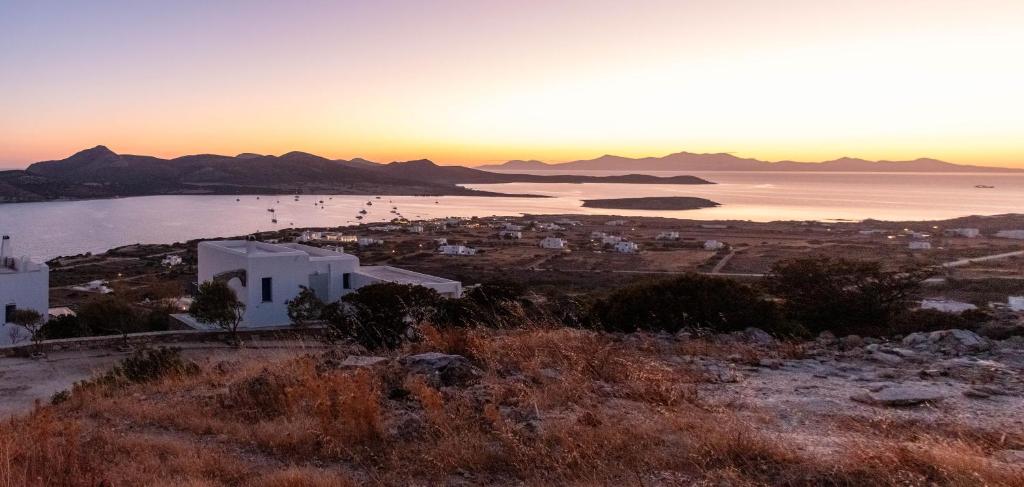 a view of a city and the ocean at sunset at Deja Blue Villa 1 in Agios Georgios