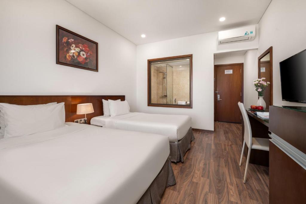 Postel nebo postele na pokoji v ubytování Mitisa Hotel Da Nang - Near Dragon Bridge