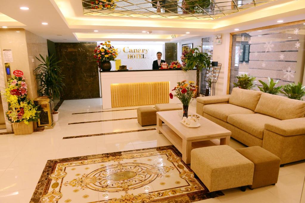 a lobby with a couch and a table in a store at Canary Ha Noi Hotel in Hanoi