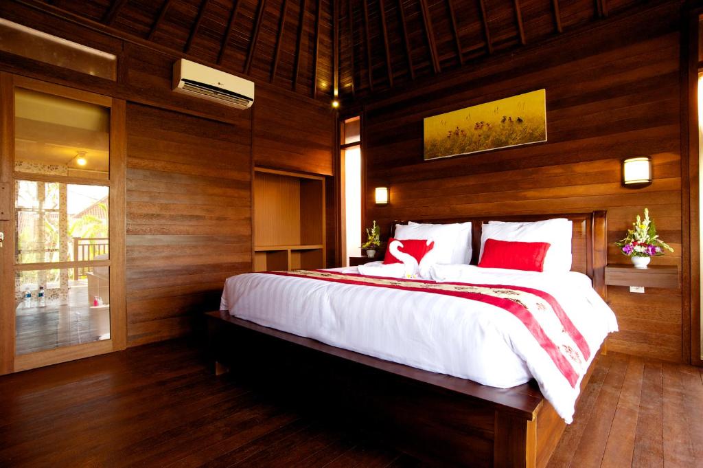Postel nebo postele na pokoji v ubytování Saka Village Resort Ubud