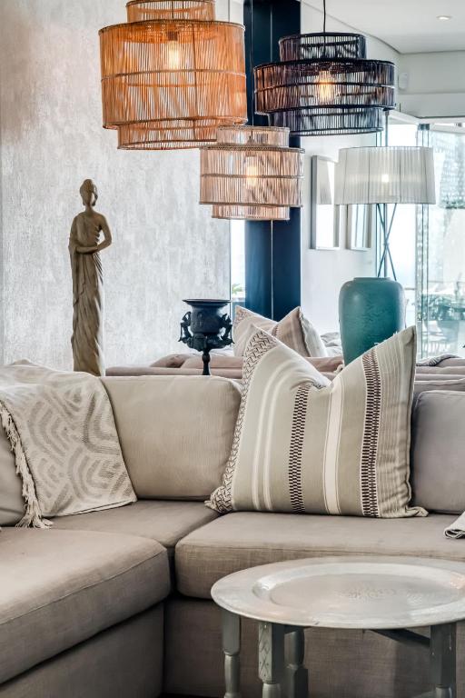 a living room with a couch and a table at Ocean Vue in Cape Town