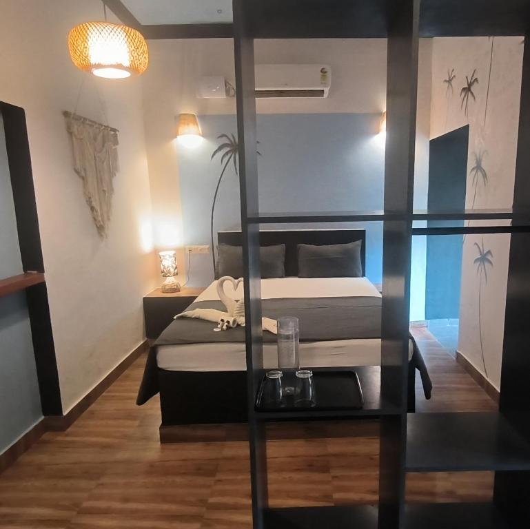 a bedroom with a bed and a glass wall at Mad about Coco Yoga & Beach Retreat in Varkala
