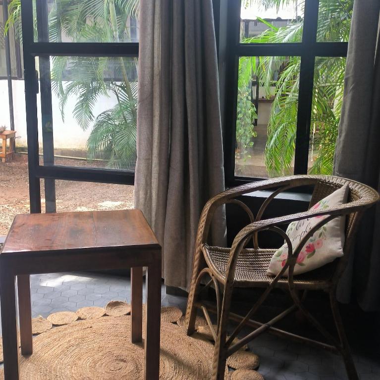 a chair and a chair and a chair and a window at Mad about Coco Yoga & Beach Retreat in Varkala