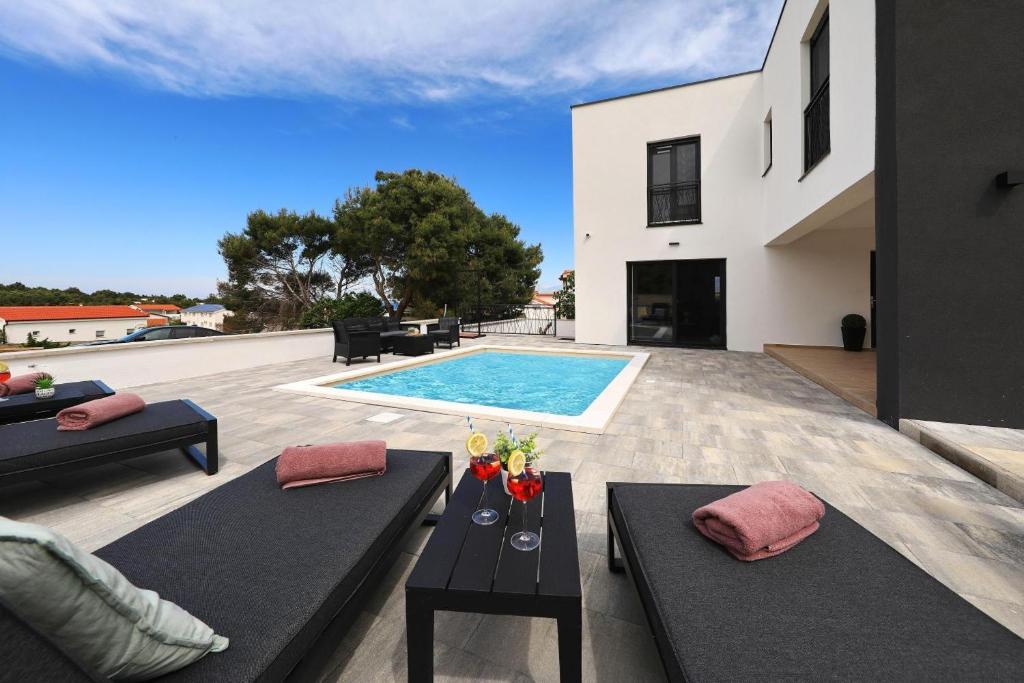 a villa with a swimming pool and a house at Vila Beny in Vir