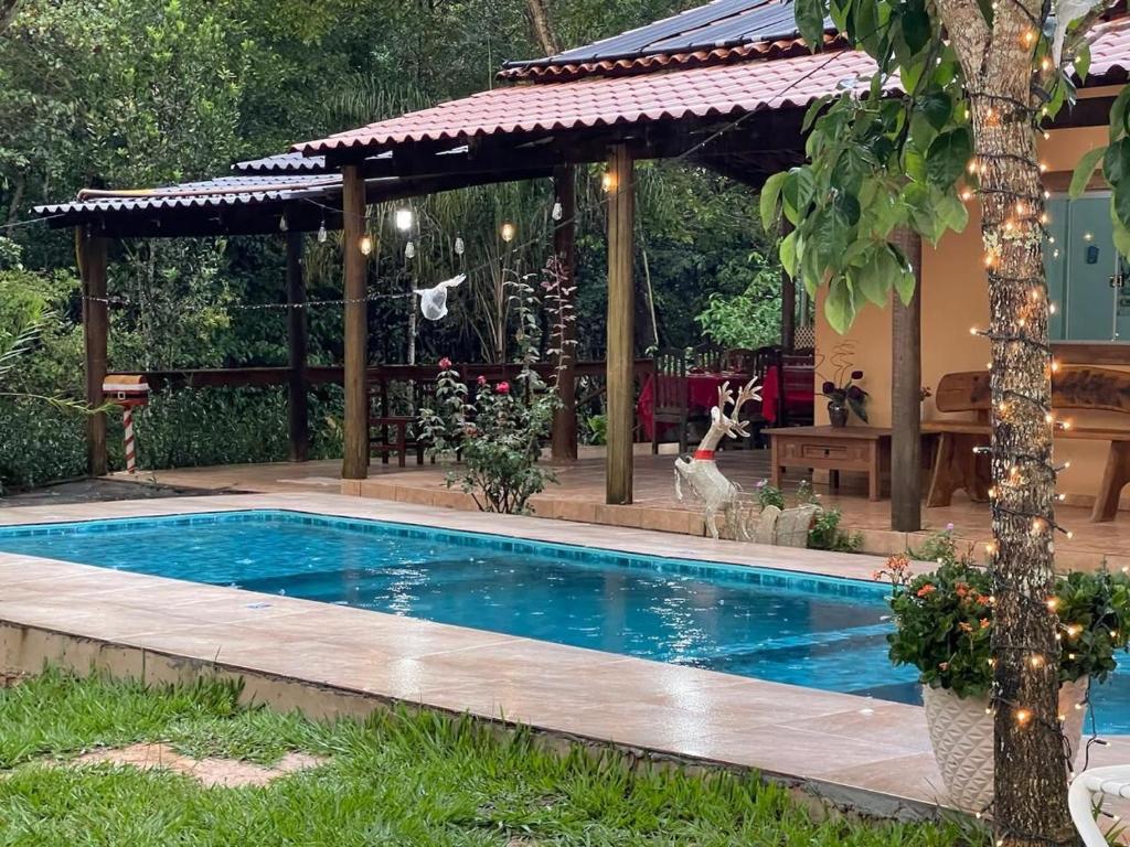 a swimming pool in a backyard with a gazebo at Sítio Matinha - Chap dos Veadeiros - São João dAliança in São João da Aliança