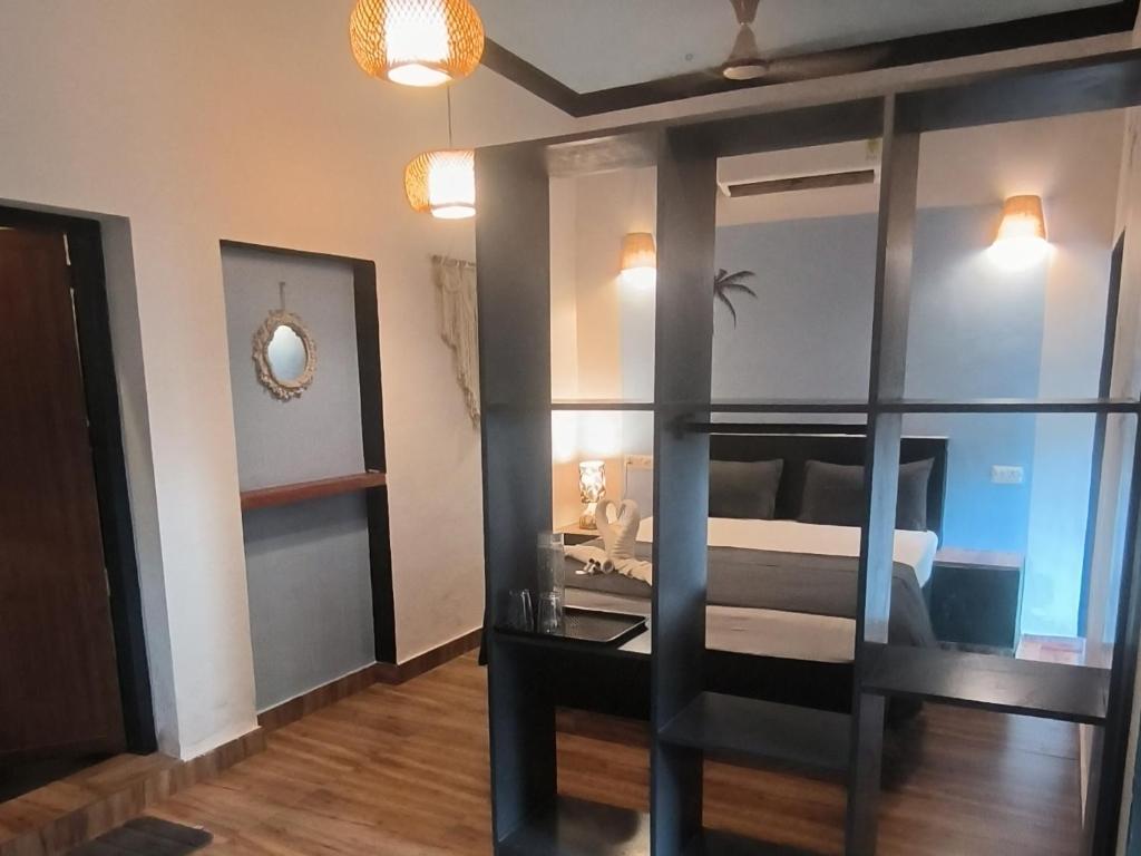 a room with a bed and a glass wall at Mad about Coco Yoga & Beach Retreat in Varkala