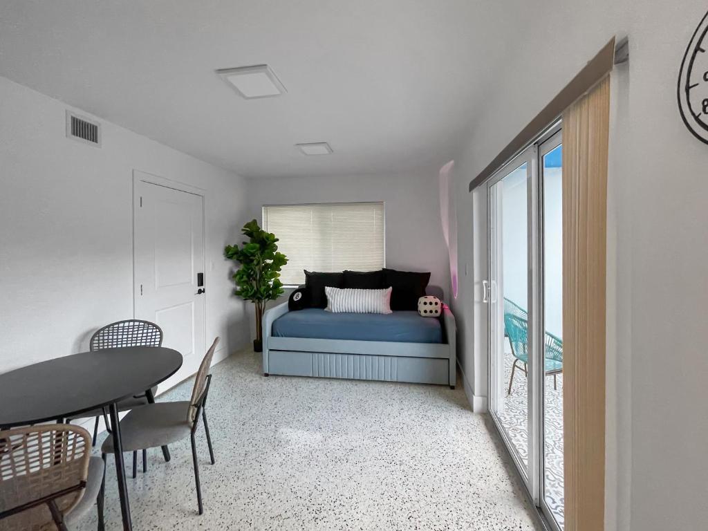 a bedroom with a bed and a table and chairs at Newly Remodeled full Apartment in Miami