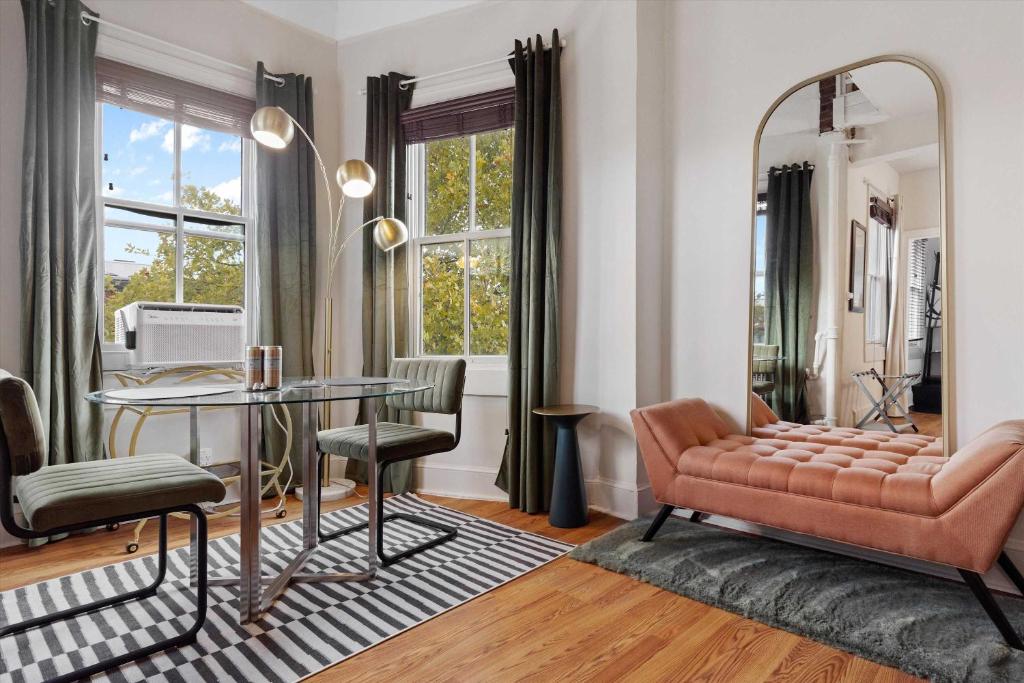 a living room with a table and a mirror at Chic 1-BR Loft Nestled Between Dupont & Logan in Washington, D.C.