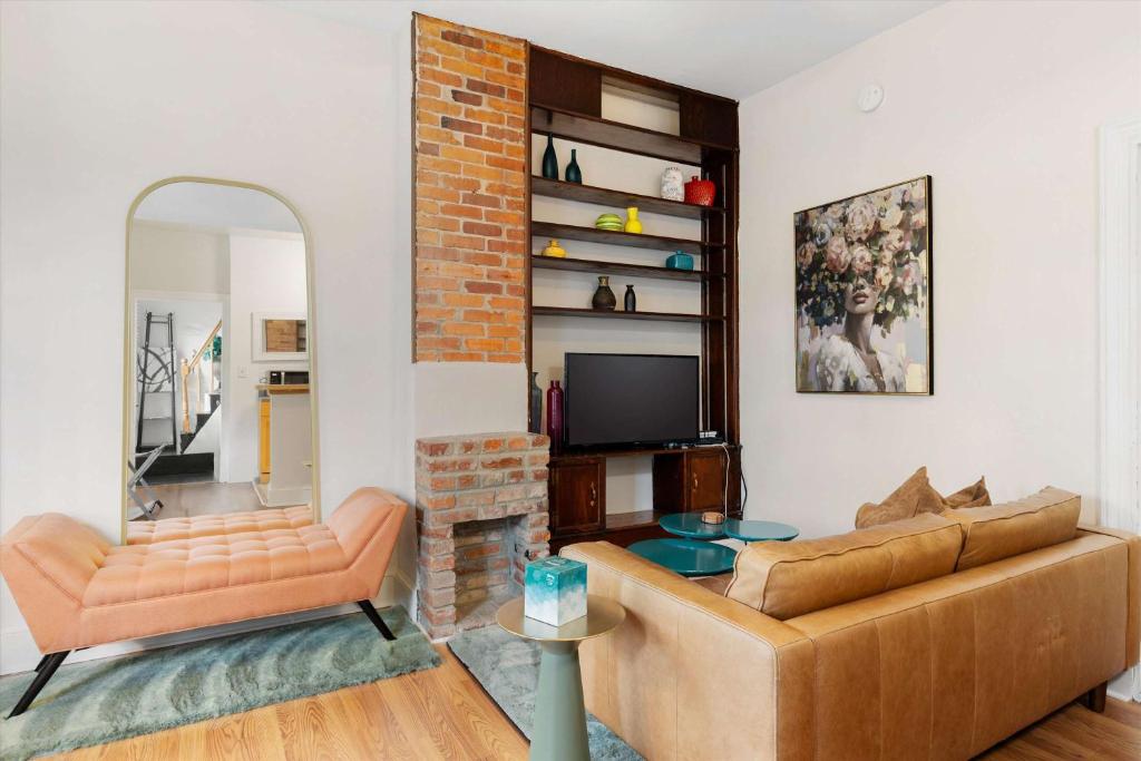a living room with a couch and a television at Chic 1-BR Loft Nestled Between Dupont & Logan in Washington, D.C.