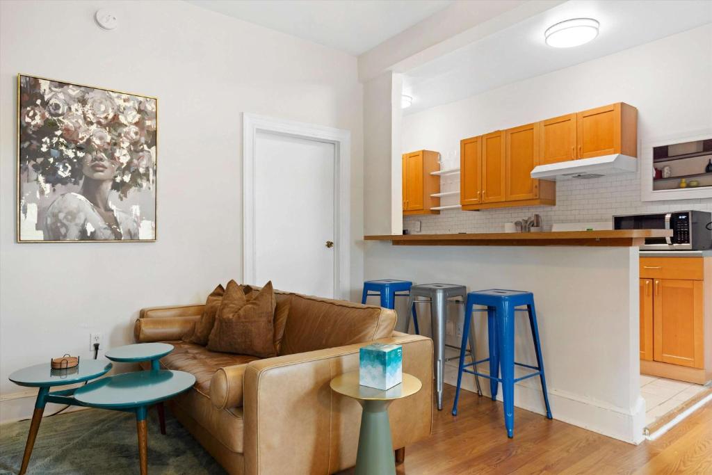 a living room with a couch and a kitchen at Chic 1-BR Loft Nestled Between Dupont & Logan in Washington, D.C.
