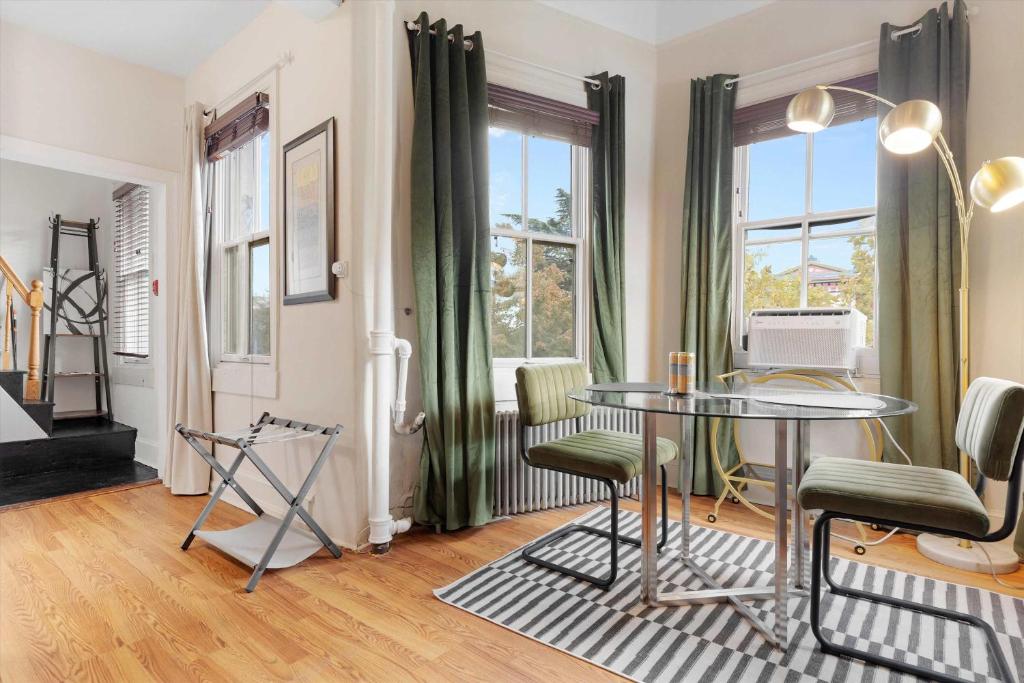 a dining room with a glass table and chairs at Chic 1-BR Loft Nestled Between Dupont & Logan in Washington, D.C.