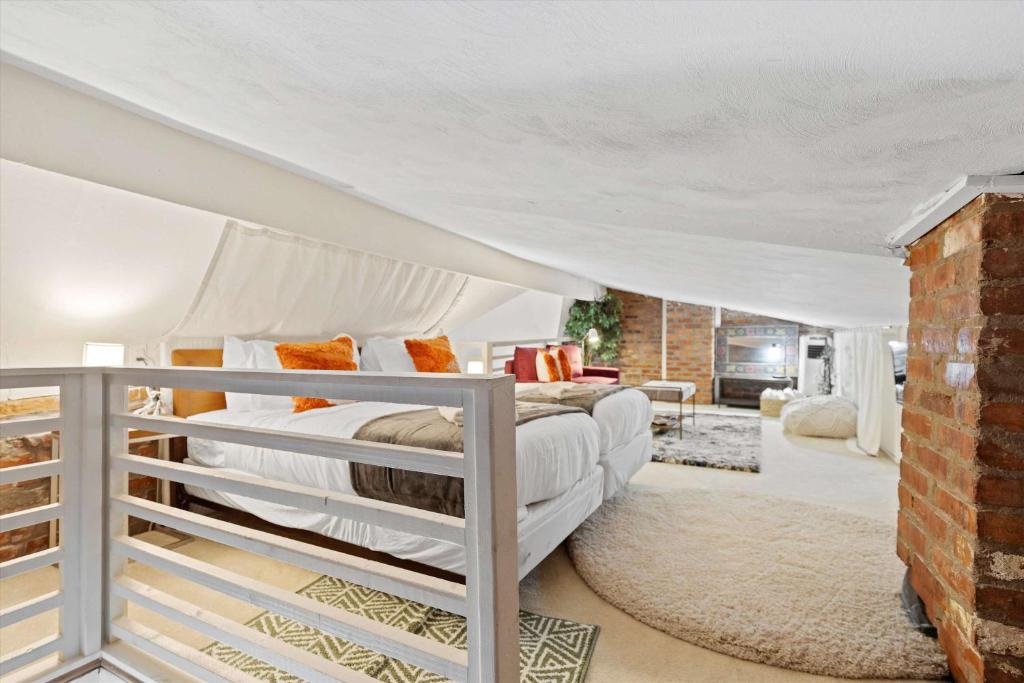 a bedroom with two bunk beds and a brick wall at Chic 1-BR Loft Nestled Between Dupont & Logan in Washington, D.C.
