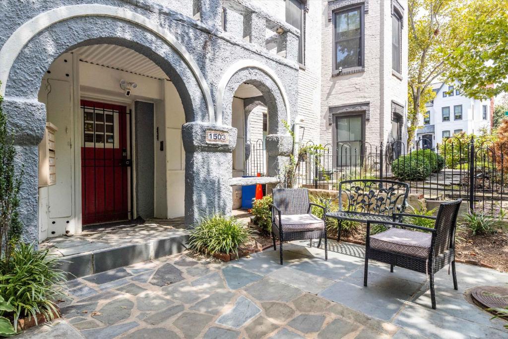 a patio with two chairs and a table in front of a building at Chic 1-BR Loft Nestled Between Dupont & Logan in Washington, D.C.