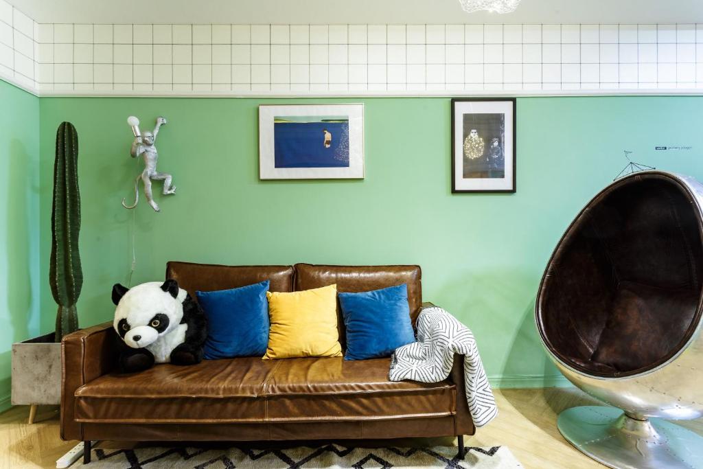 a panda bear sitting on a couch in a room at Chengdu city center Tianfu Square Kuanzhai Alley People's Park subway post-modern design 85 square meters 2 bedrooms 1 living room design B&B HD cinema family suite in Chengdu