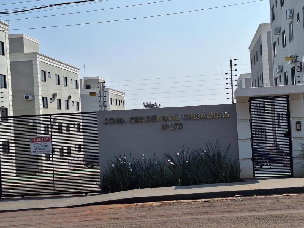a building with a sign that readsomed residential clusters at Crisálias Apartamento in Foz do Iguaçu