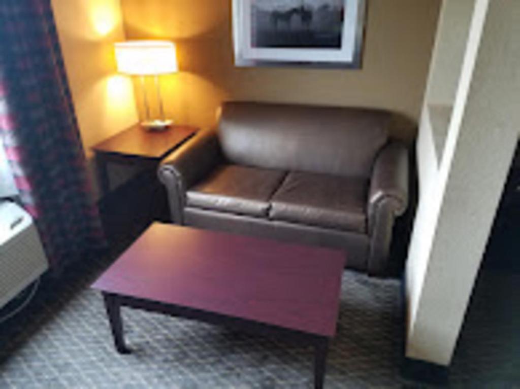 a living room with a couch and a coffee table at Baymont by Wyndham Ardmore I-35 in Ardmore