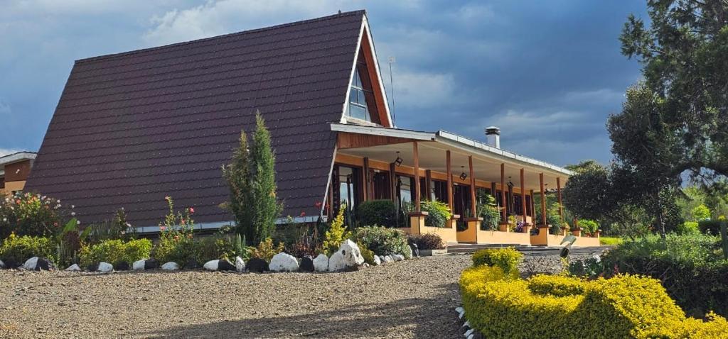 a large building with a garden in front of it at Juniper Park Resort in Nyahururu