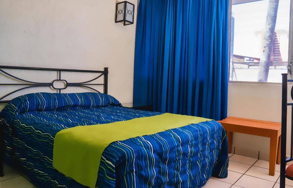 Postel nebo postele na pokoji v ubytování Hotel Arboledas Expo