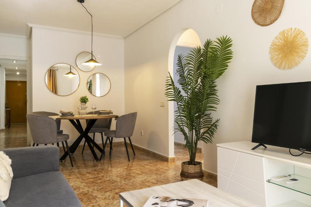 Televízia a/alebo spoločenská miestnosť v ubytovaní Apartamento Pink Medsea