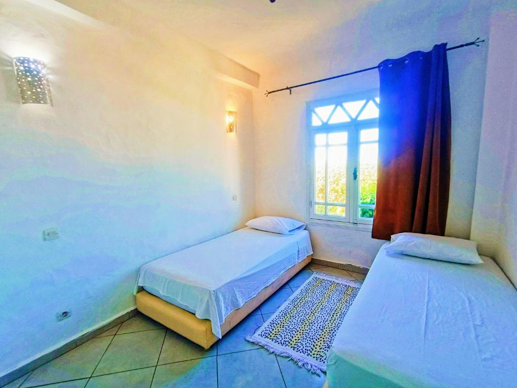 Tempat tidur dalam kamar di P1 duplex vue sur Mer