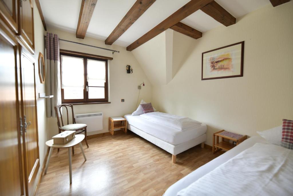Postel nebo postele na pokoji v ubytování Gîte Vignoble de Cléebourg