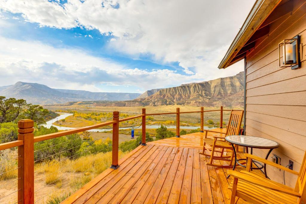 a wooden deck with chairs and a table on it at Colorado River Getaway in Parachute Dogs Welcome! in Parachute
