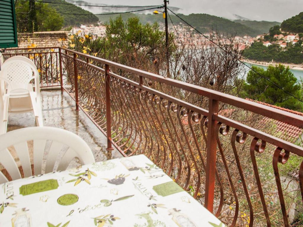 a table and chairs on a balcony with a view at Apartment Hajdi in Pučišća