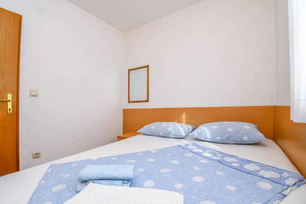 Postel nebo postele na pokoji v ubytování Apartments Jakov