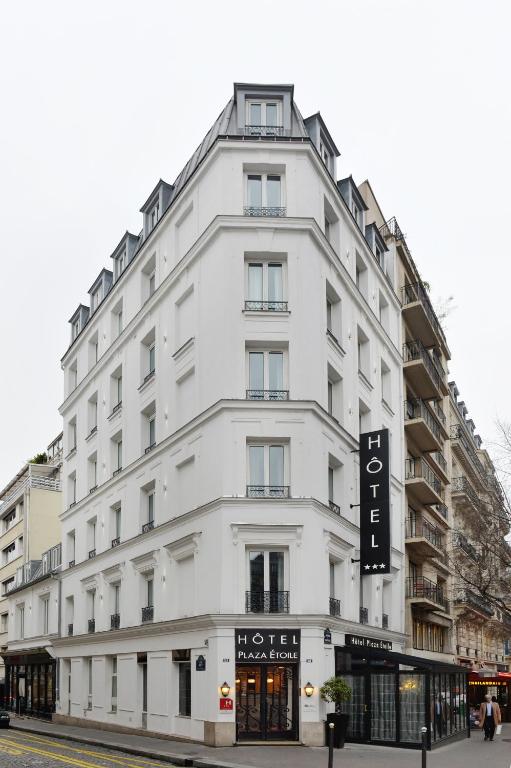 a white building with a sign on the side of it at Hôtel Plaza Étoile in Paris