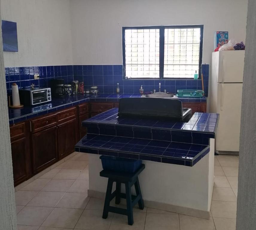 a kitchen with blue tiled counters and a counter top at Malecon Beach House in Progreso 1 block from beach in Progreso