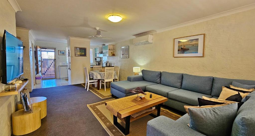 a living room with a couch and a table at Swell Villa 6 - Kalbarri, WA in Kalbarri