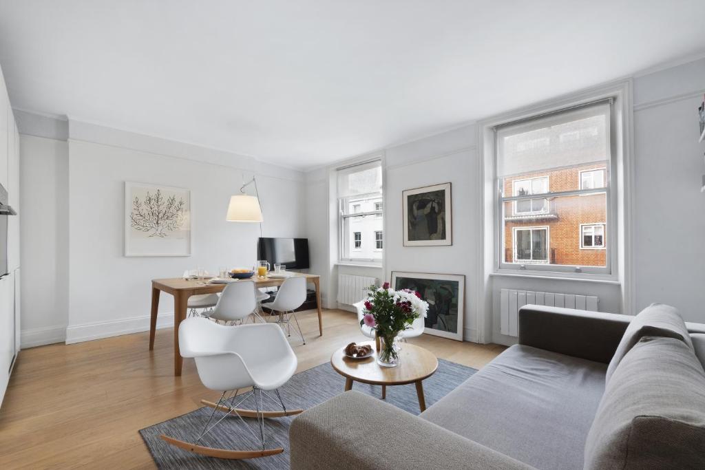 a living room with a couch and a table at Crawford Street Apartment By Morethanstays in London