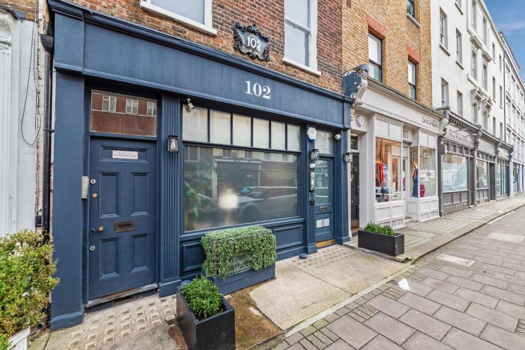 a blue store front on a city street at Crawford Street Apartment By Morethanstays in London