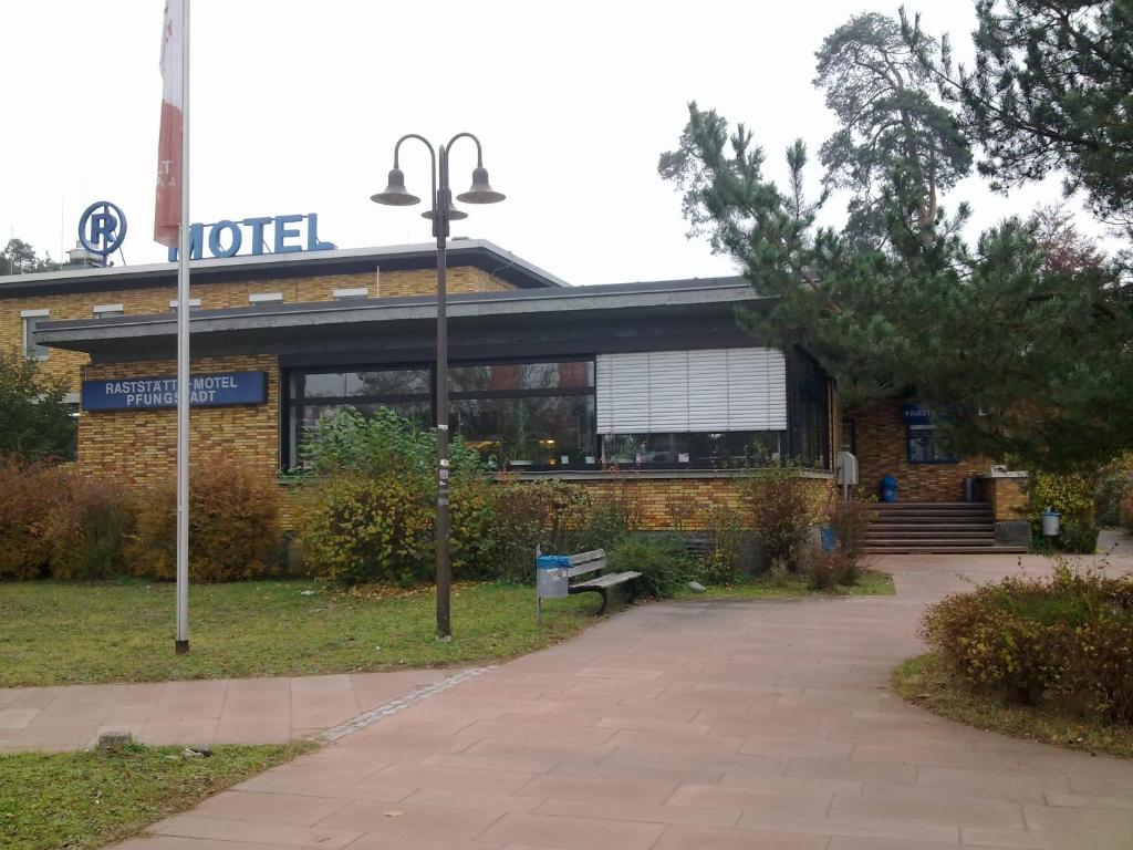 a building with a sign for a hotel at Autobahn Hotel Pfungstadt Ost in Pfungstadt