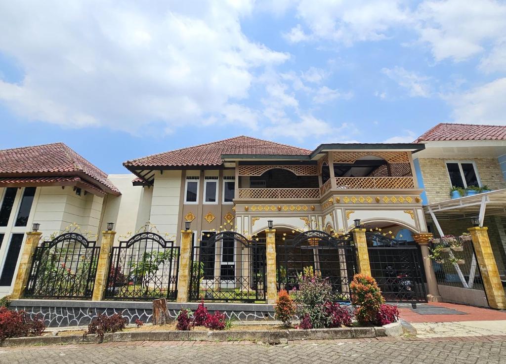 a house with a fence in front of it at Amjad5 in Cipanas