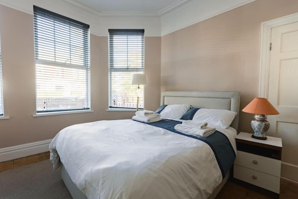 a bedroom with a large bed with two towels on it at Hullidays University 2 Bed Ground Floor Apartment in Hull