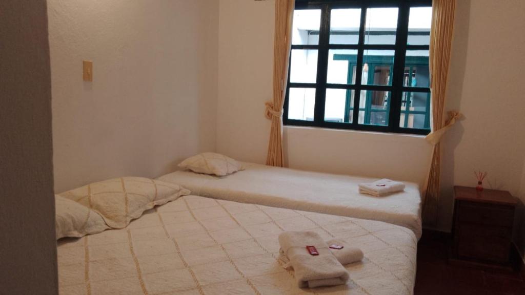 Postel nebo postele na pokoji v ubytování Hostal casa de los sueños