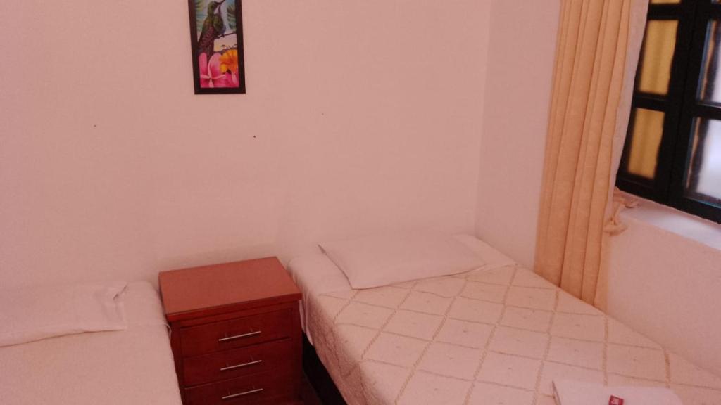 Postel nebo postele na pokoji v ubytování Hostal casa de los sueños