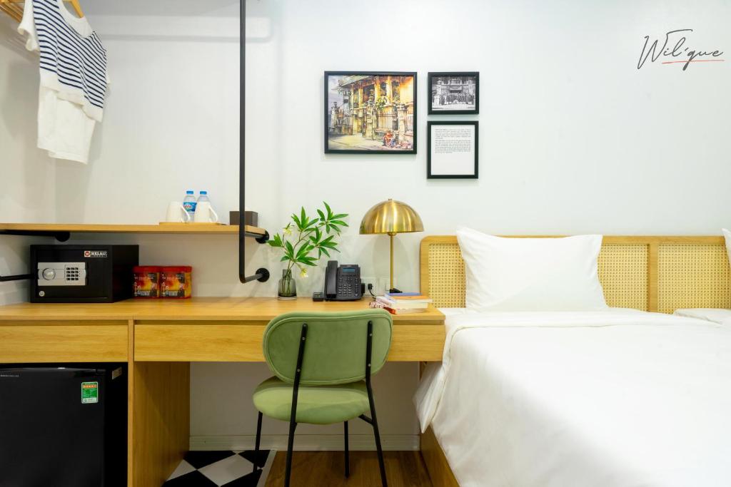 Postel nebo postele na pokoji v ubytování Wilque Hotel Hanoi