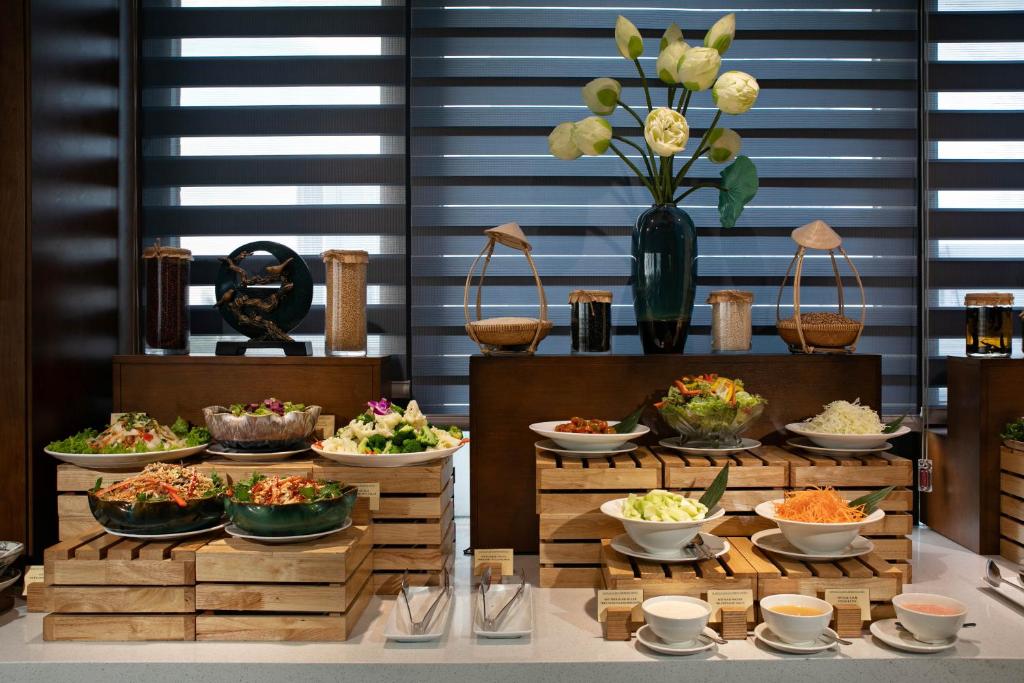 A self-service buffet counter with salads, vegetables, rice and condiments.